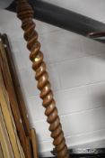 An early 20th Century oak standard lamp having twist column