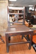 A 19th Century solid seat dining chair having rail and splat back