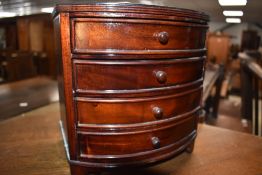 A reproduction specimen chest/jewellery box modelled as a bow fronted chest of drawers, width