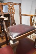 A reproduction hardwood carver chair in the Georgian style