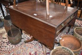 A 19th Century Regency style pembroke table on quadruple legs with brass castors