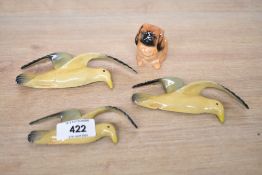 A Royal Doulton bone china small Pikenese dog study sold alongside three amateur seagull wall