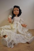 A 1950's Milano Doll having sleep eyes, closed mouth, jointed body, fully clothed with original size