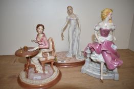 A group of three female figures, to include Cinderella by Franklin Mint, h26cm, a Jane Austen's Emma