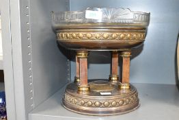 A 20th century brass and glass centre piece in the Adams style, having a cut glass bowl supported on