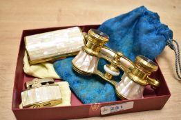A pair of 20th century brass opera glasses having folding handle with mother of pearl inlay, sold