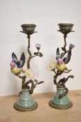 A pair of decorative cast-gilt metal and porcelain candlesticks, formed as naturalistic sinuous