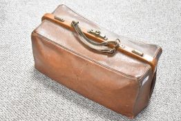 A early 20th century brown leather cladstone bag, w46cm