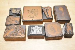 A group of vintage printing blocks, subject matters include Spanish waiter, country landscape