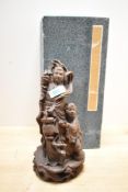 An early 20th century Chinese wooden carving having carved female figure with a boy by her side,