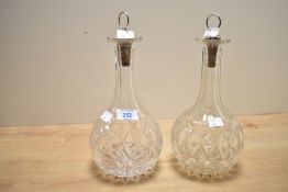 A pair of cut crystal decanters of onion form, having cork stoppers, h26cm