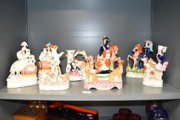 A 19th century Staffordshire pottery figure of a trio of dogs, modelled with a central figure of a