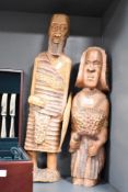 A pair of wooden African sculptures, hand carved with shield, missing spear, largest h63cm, ( 2 ).