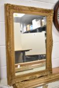 An ornate rectangular wall mirror decorated with floral patterns on a gold colour ground, h74cm,
