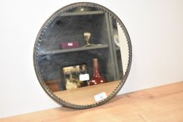 A vintage circular mirrored confectionary stand wih fluted edge detail, the painted metal reverse