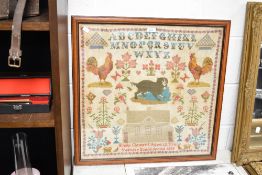 An attractive 19th century framed needlework pictorial alphabet sampler, depicting the alphabet, two