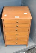 A wooden table top chest having 6 graduating drawers, h38cm
