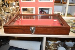 A small mahogany and glass jewellery display case having red cloth interior and Cheney metal