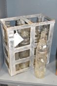 A 20th century metal carry crate holding 6 glass Essolube bottles, h43cm, sold together with another