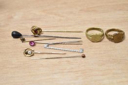 A small collection of rings and stick pins, including signet rings, knot and horseshoe motif pins