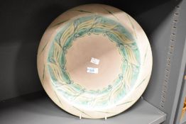 An early 20th century Royal Lancastrian lapis ware bowl painted with green motifs on a grey
