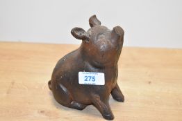 A heavy cast iron sitting pig sculpture, h14cm