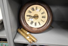 A vintage Continental painted metal circular wall clock, with exposed movement and two cylindrical