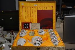 A 20th century Chinese Hongguanyao porcelain tea service in a silk upholstered box, comprising of