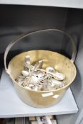A brass jam pan containing a large quantity of silver plated spoons and forks, approximately 41