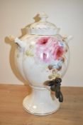 A Royal Premium semi-porcelain lidded Samovar, having gilt edging and floral designs, raised on a