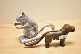 A aluminium squirrel form nut cracker, h15cm, sold together with a cast iron dog nut cracker, (2)