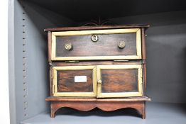 An interesting reproduction 'apprentice piece' or miniature secretaire, having a raised and scrolled