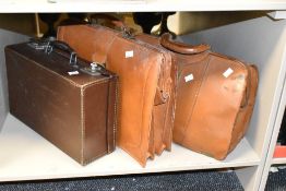 Two early 20th century brown leather brief cases, largest W45cm, sold together with a brown case, (