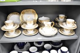 A Japanese Meito pattern part dinner service, hand coloured with gilt floral patterns on a white