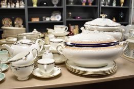 A Wedgwood Osborne pattern dinner service decorated with gilt edging and floral border, to include a