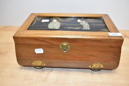 A large Chinese wooden jewellery box, containing an assortment of costume jewellery including beaded