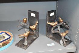 An attractive pair of iron bookends having gold colour birds perched on branches, h15cm