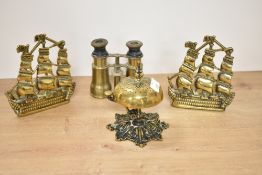 A pair of brass book ends in the form of galleons, h13.5cm, sold together with a brass bell and pair