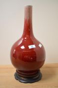 A Chinese porcelain Sand de Boeuf onion or bottle form vase, having a cylindrical neck over the