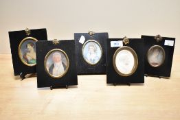 A 19th century miniature of a gentleman held under glass within a black lacquered frame, h13cm, sold