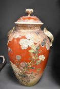 A large Japanese Satsuma pottery vase with cover having figural finale, decorated with flowers,