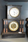 A 19th century black slate mantel clock of square form having enamelled dial with two winding holes,