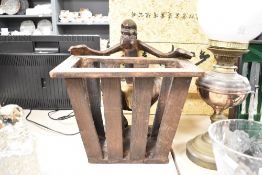 An unusual carved wooden tribal souvenier newspaper rack having Papua New Guinea figure, h38cm