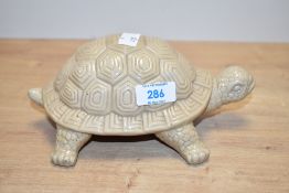 A glazed ceramic tortoise in cream colour, L21cm