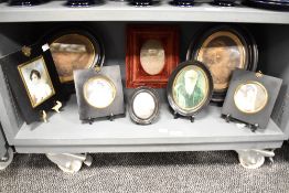 A 19th century miniature oval print of a gentleman held under glaze within a black lacquered