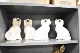 A pair of late 19th / early 20th century Staffordshire spaniel dogs, h24cm, sold together with two