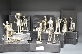 A group of Royal Hampshire Art Foundry silver plated figures and figurines including a flute player,