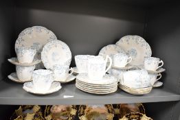 A Foley fine bone china part dinner service, decorated with gilt edging and blue floral patterns