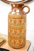 A large West German pottery jug decorated with geometric patterns on a brown glazed ground, model