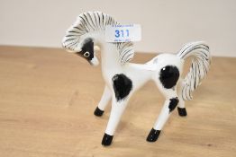 A vintage ceramic Pony having black spots on a white body, painted mark for Italy to base, h13cm